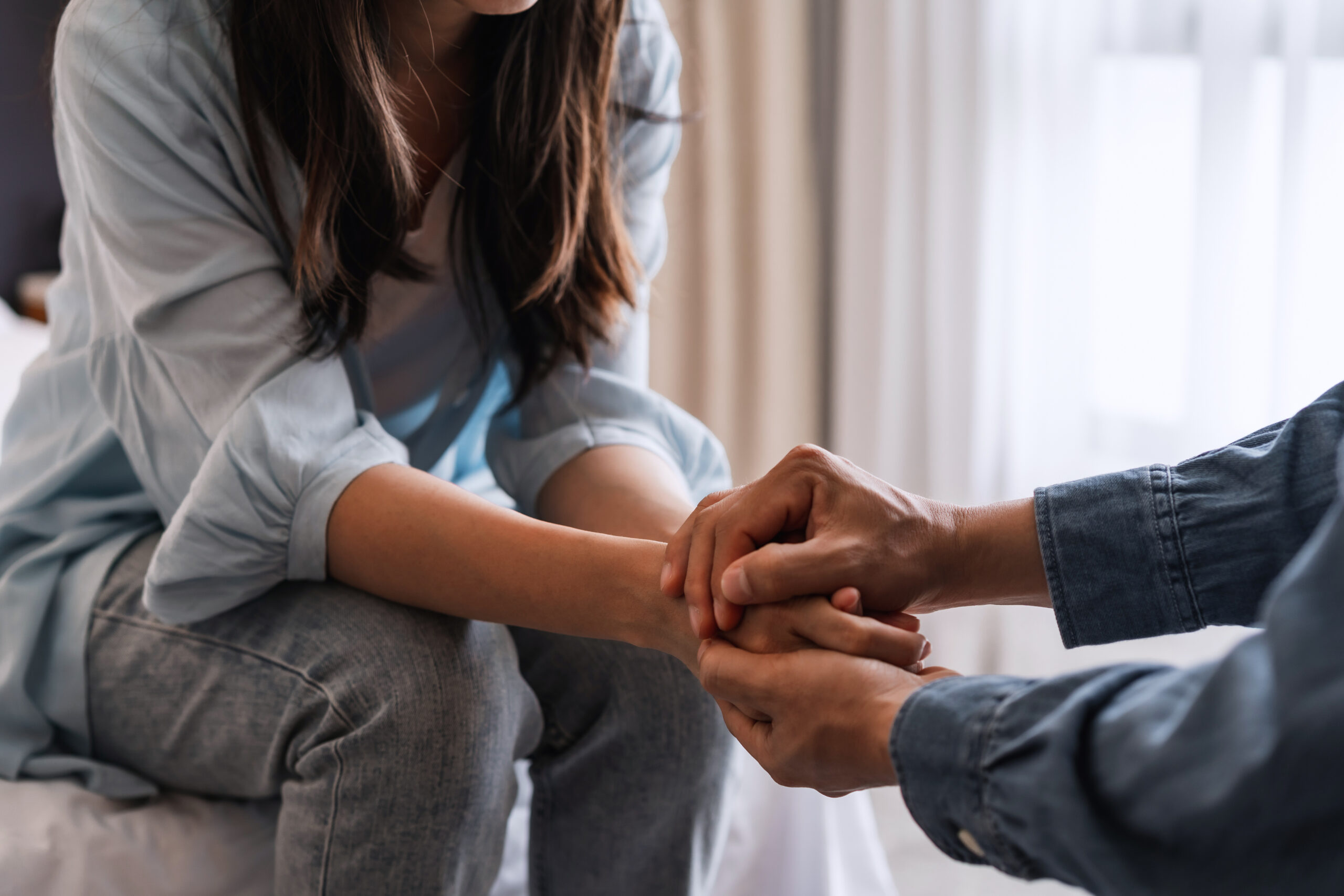 Young Man Comforting And Supporting A Sad Woman Who Is In Serious Trouble At Home, Consolation And Encouragement Concept