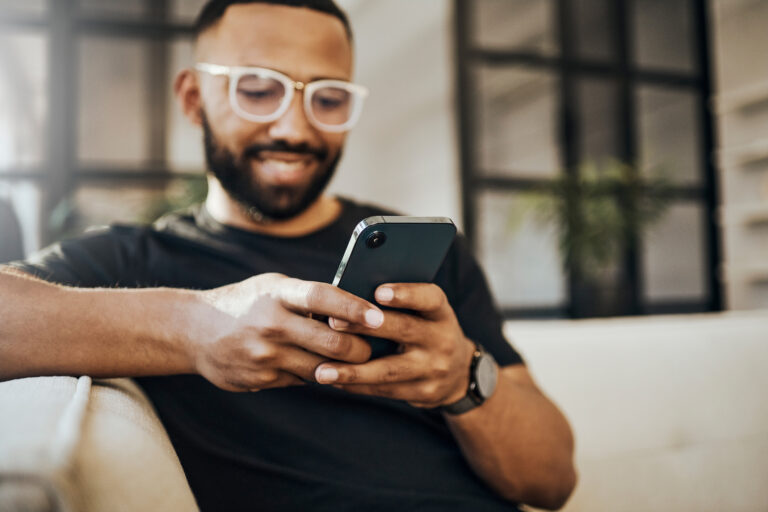 Happy Man, Social Media Phone And Living Room Relax, Typing Smartphone And Online Communication, Reading Notification And Web On Sofa. Smile Guy Hands, Mobile Connection And Home Network Technology